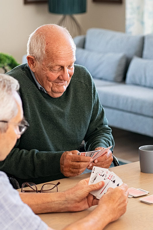 Senior residents enjoying a card game in a shared common area
