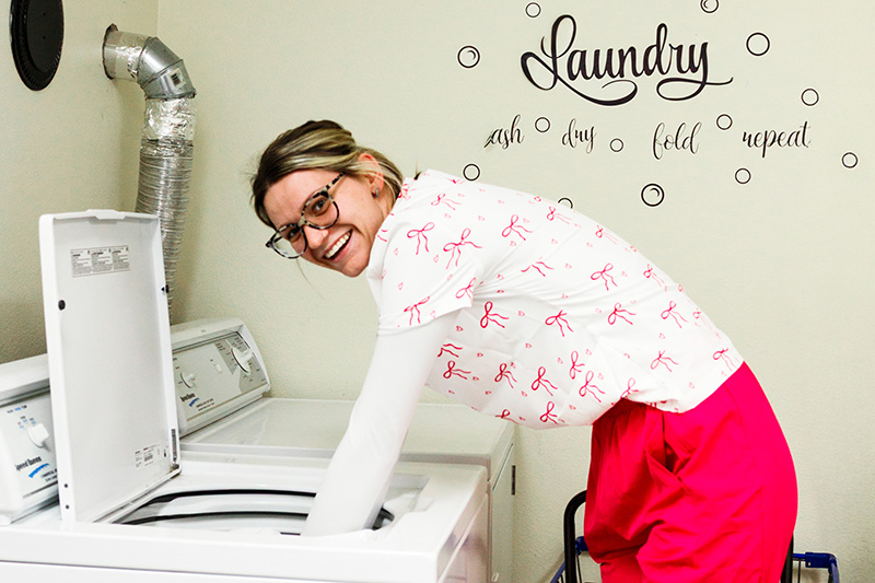 Staff member doing laundry for residents at Cornerstone Residence of Oklee
