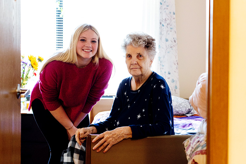 Family member visiting a resident in her private suite at Cornerstone Residence of Oklee